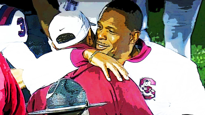 Nov. 14, 2025; NCCU HC Trei Oliver and SCS HC Chennis Berry embrace at midfield after the Bulldogs defeated the Eagles, 34-27, in Durham, NC.