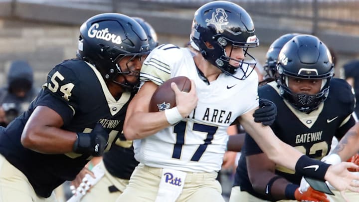 Gateway offensive defensive lineman Kaiyen Mbandi, left, looks to grab ahold of Kiski quarterback Landyn Artman during a game earlier this fall. The Gators' senior was chosen as a member of the PSFCA West Large School team for the East vs. West game on May 17 at Cumberland Valley High School.