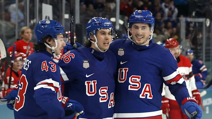 Feb 14, 2026; Milan, Italy;   Jack Hughes of United States celebrates scoring their sixth goal with teammates against Denmark in men's ice hockey group C play during the Milano Cortina 2026 Olympic Winter Games at Milano Santagiulia Ice Hockey Arena. Mandatory Credit: Geoff Burke-Imagn Images