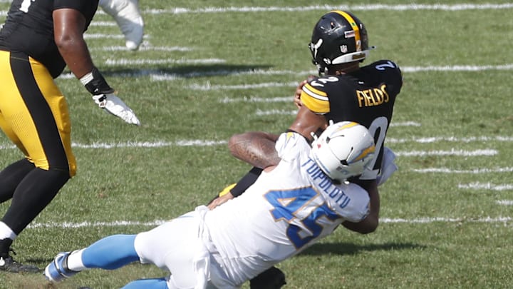 Sep 22, 2024; Pittsburgh, Pennsylvania, USA;  Los Angeles Chargers linebacker Tuli Tuipulotu (45) sacks Pittsburgh Steelers quarterback Justin Fields (2) during the third quarter at Acrisure Stadium. Pittsburgh won 20-10. Mandatory Credit: Charles LeClaire-Imagn Images