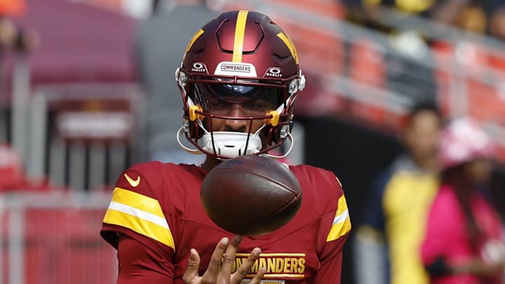 Oct 6, 2024; Landover, Maryland, USA; Washington Commanders quarterback Jayden Daniels (5) spins a ball on his finger during warmup prior to the game against the Cleveland Browns at NorthWest Stadium. Mandatory Credit: Geoff Burke-Imagn Images