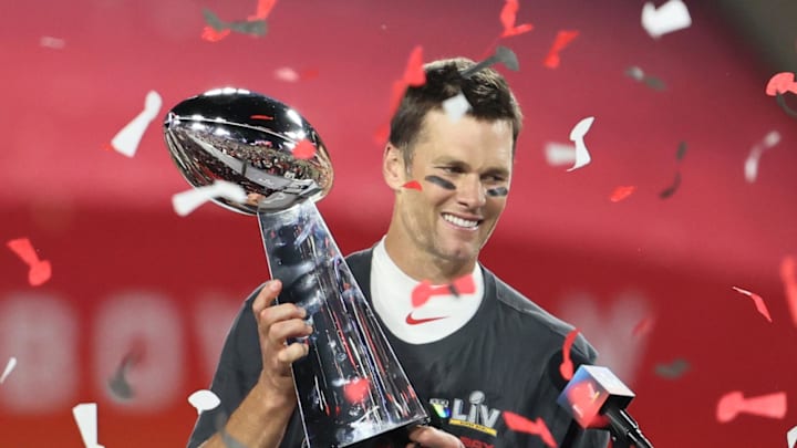 Feb 7, 2021; Tampa, FL, USA; Tampa Bay Buccaneers quarterback Tom Brady (12) hoists the Vince Lombardi Trophy after defeating the Kansas City Chiefs in Super Bowl LV at Raymond James Stadium.  Mandatory Credit: Matthew Emmons-Imagn Images