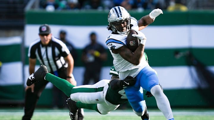 Carolina Panthers running back Rico Dowdle (5) runs the ball as New York Jets linebacker Jamien Sherwood (44) attempts a tackle during a game at MetLife Stadium, Oct 19, 2025, East Rutherford, NJ, USA.
