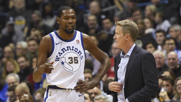 Golden State Warriors head coach Steve Kerr talks to forward Kevin Durant.