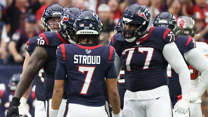 Nov 5, 2023; Houston, Texas, USA; Houston Texans offensive tackle George Fant (77) reacts to  C.J. Stroud (7) touchdown pass against the Tampa Bay Buccaneers in the fourth quarter at NRG Stadium. Mandatory Credit: Thomas Shea-Imagn Images