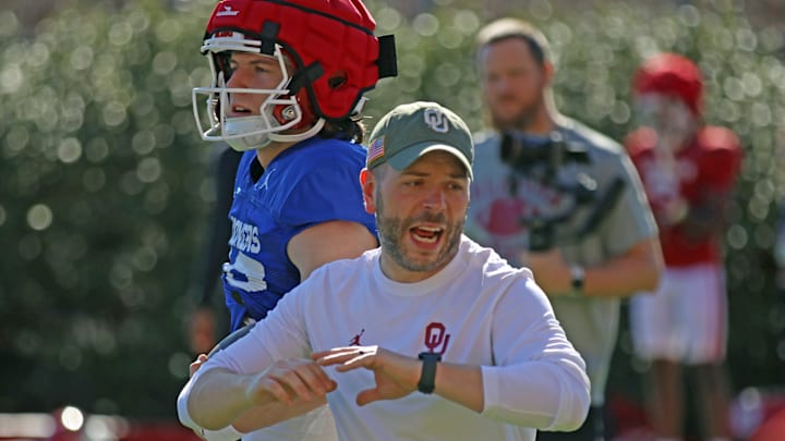 Oklahoma quarterback John Mateer (rear) and assistant QB coach John Kuceyeski.