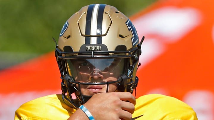 Purdue Boilermakers quarterback Marcos Davila (5) adjusts hit helmet Friday, Aug. 9, 2024, during Purdue football practice at Bimel Outdoor Practice Complex in West Lafayette, Ind.