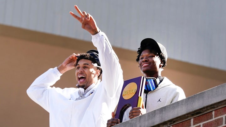 Michigan forward Yaxel Lendeborg (23) and guard L.J. Cason (2) wave to fans on Tuesday, April, 7, 2026, at Crisler Center after the team arrived home after winning the NCAA national championship, 69-63, against Connecticut.