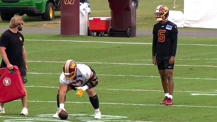 Washington Commanders center Nick Allegretti prepares to snap the ball to quarterback Jayden Daniels during practice on Aug. 31, 2026, in Ashburn, Virginia, after returning to the field following an extended absence.