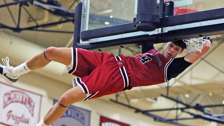 Sherwood junior Brody Rygh throws down a second-quarter dunk during the Bowmen’s 62-48 victory at Century.