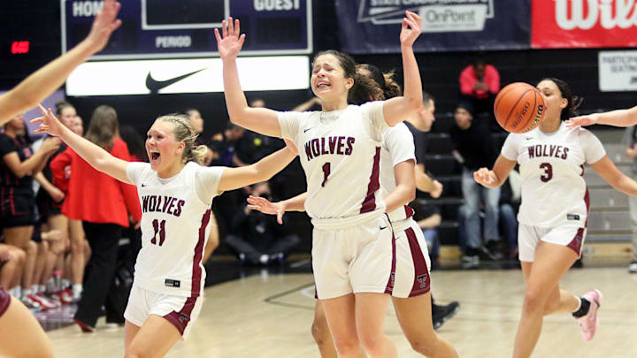 Members of the Tualatin girls basketball team, including Ries Miadich (11), Love Lei Best (1) and Jordyn Smith (3), celebrate after rallying from a 19-point deficit to notch a 63-58 win over Clackamas in the Class 6A state championship game.