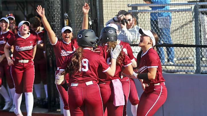 The Sherwood softball squad celebrates after junior Daisha Cornwell (6) scores the team’s first run in a 10-1 win over Mountainside.