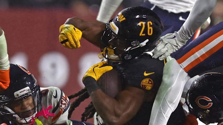 Washington Commanders running back Jeremy McNichols dives for a first down against the Chicago Bears.