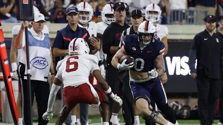 Sep 20, 2025; Charlottesville, Virginia, USA; Virginia Cavaliers tight end Sage Ennis (0) runs with the ball after making a catch as Stanford Cardinal cornerback Collin Wright (6) defends during the first quarter at Scott Stadium. Mandatory Credit: Geoff Burke-Imagn Images Sep 20, 2025; Charlottesville, Virginia, USA; Virginia Cavaliers tight end Sage Ennis (0) runs with the ball after making a catch as Stanford Cardinal cornerback Collin Wright (6) defends during the first quarter at Scott Stadium. Mandatory Credit: Geoff Burke-Imagn Images