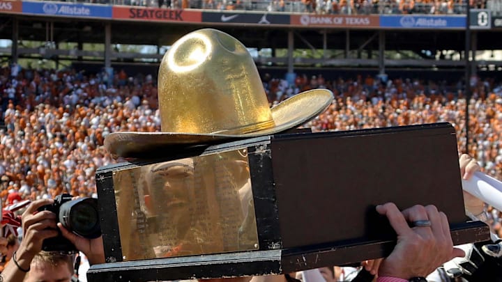 The Golden Hat Trophy is raised after the Red River Rivalry college football game between the University of Oklahoma Sooners (OU) and the University of Texas (UT) Longhorns at the Cotton Bowl in Dallas, Saturday, Oct. 7, 2023. Oklahoma won 34-30. The Golden Hat Trophy is raised after the Red River Rivalry college football game between the University of Oklahoma Sooners (OU) and the University of Texas (UT) Longhorns at the Cotton Bowl in Dallas, Saturday, Oct. 7, 2023. Oklahoma won 34-30.