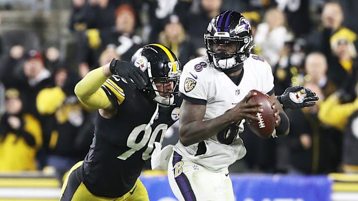 Dec 5, 2021; Pittsburgh, Pennsylvania, USA; Pittsburgh Steelers outside linebacker T.J. Watt (90) pressures Baltimore Ravens quarterback Lamar Jackson (8) during the fourth quarter at Heinz Field. Pittsburgh won 20-19. Mandatory Credit: Charles LeClaire-Imagn Images