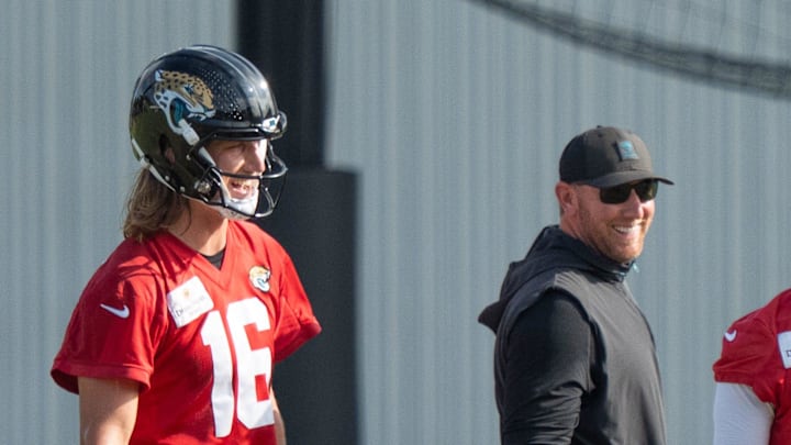 Jacksonville Jaguars quarterback Trevor Lawrence (16) and Jacksonville Jaguars head coach Liam Coen have a laugh during the Jaguar’s 12th NFL training camp session at the Miller Electric Center, Thursday, Aug. 7, 2025, in Jacksonville, Fla. [Doug Engle/Florida Times-Union]