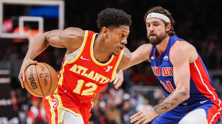 Dec 18, 2023; Atlanta, Georgia, USA; Atlanta Hawks forward De'Andre Hunter (12) drives on Detroit Pistons forward Joe Harris (31) in the second quarter at State Farm Arena. Mandatory Credit: Brett Davis-USA TODAY Sports