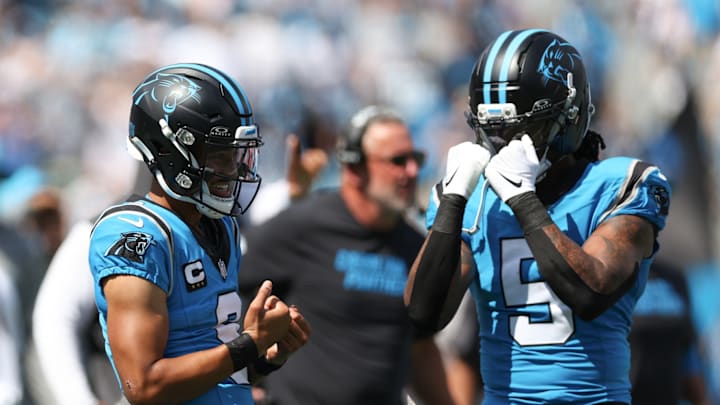 Sep 21, 2025; Charlotte, North Carolina, USA; Carolina Panthers quarterback Bryce Young (left) celebrates with running back Rico Dowdle (5) after scoring a touchdown during the second half of a game against the Atlanta Falcons at Bank of America Stadium. 