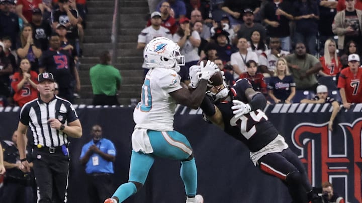 Dec 15, 2024; Houston, Texas, USA; Houston Texans cornerback Derek Stingley Jr. (24) intercepts the ball against Miami Dolphins wide receiver Tyreek Hill (10) in the fourth quarter at NRG Stadium. Mandatory Credit: Thomas Shea-Imagn Images