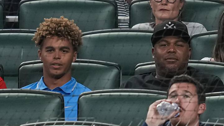 Jun 7, 2022; Cumberland, Georgia, USA; Former Atlanta Braves player Andruw Jones (right) and his son Druw watch the game between the Braves and the Oakland Athletics during the sixth inning at Truist Park. Mandatory Credit: Dale Zanine-Imagn Images