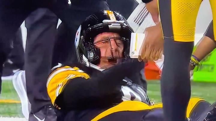 Aaron Rodgers reacts to being tackled by a teammate after throwing a touchdown pass. 