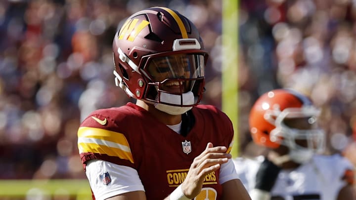 Oct 6, 2024; Landover, Maryland, USA; Washington Commanders quarterback Marcus Mariota (18) smiles while jogging onto the field against the Cleveland Browns during the fourth quarter at NorthWest Stadium. Mandatory Credit: Geoff Burke-Imagn Images