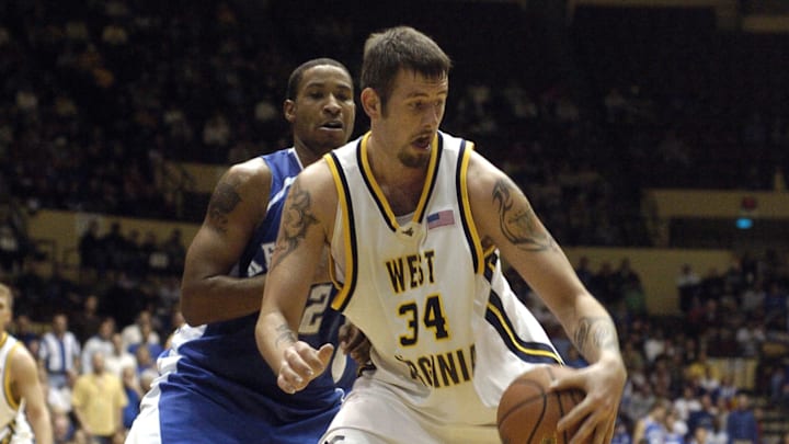 Nov 22, 2005; Kansas City, MO, USA; West Virginia Mountaineers center (34) Kevin Pittsnogle drives towards the basket while being guarded by Kentucky Wildcats forward (42) Rakalin Sims in the second half at the Guardians Classic at Municipal Auditorium in Kansas City, MO. Kentucky won the game 80-66. Mandatory Credit: John Rieger-Imagn Images Copyright (c) 2005 John Rieger Nov 22, 2005; Kansas City, MO, USA; West Virginia Mountaineers center (34) Kevin Pittsnogle drives towards the basket while being guarded by Kentucky Wildcats forward (42) Rakalin Sims in the second half at the Guardians Classic at Municipal Auditorium in Kansas City, MO. Kentucky won the game 80-66. Mandatory Credit: John Rieger-Imagn Images Copyright (c) 2005 John Rieger