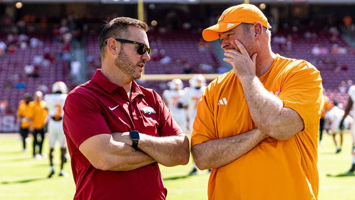 Arkansas Razorbacks coach Silverfield speaks with Tennessee Volunteers coach Josh Heupel.