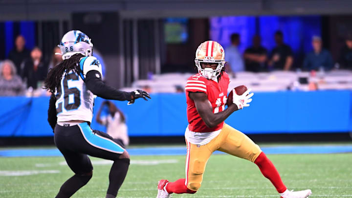 Oct 9, 2022; Charlotte, North Carolina, USA; San Francisco 49ers wide receiver Brandon Aiyuk (11) with the ball as Carolina Panthers cornerback Donte Jackson (26) defends in the fourth quarter at Bank of America Stadium. 