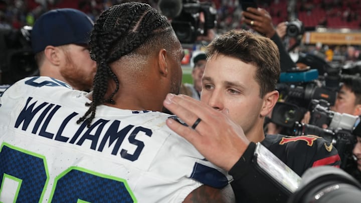 Jan 3, 2026; Santa Clara, California, USA; San Francisco 49ers quarterback Brock Purdy (13) reacts with Seattle Seahawks defensive end Leonard Williams (99) reacts after the game at Levi's Stadium. 