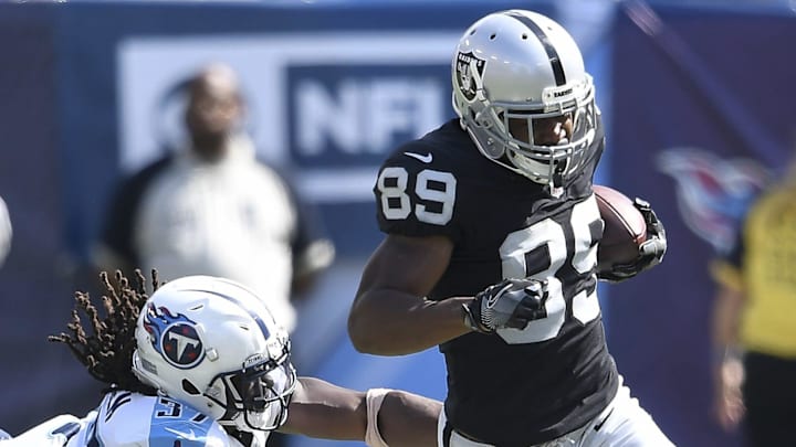 Oakland Raiders wide receiver Amari Cooper (89) slips through the grasp of Tennessee Titans strong safety Johnathan Cyprien (37) at Nissan Stadium in Nashville on Sept. 10, 2017. The Titans lost their home and season opener 26-16.