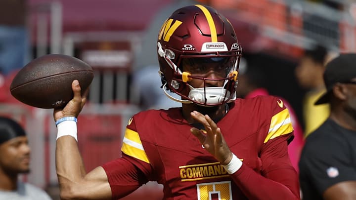 Oct 6, 2024; Landover, Maryland, USA; Washington Commanders quarterback Jayden Daniels (5) passes a ball during warmup prior to the game against the Cleveland Browns at NorthWest Stadium. Mandatory Credit: Geoff Burke-Imagn Images