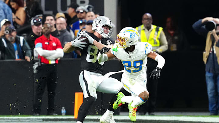 Jan 5, 2025; Paradise, Nevada, USA; Las Vegas Raiders tight end Brock Bowers (89) slips the tackle of Los Angeles Chargers cornerback Tarheeb Still (29) during the fourth quarter at Allegiant Stadium. Mandatory Credit: Stephen R. Sylvanie-Imagn Images Jan 5, 2025; Paradise, Nevada, USA; Las Vegas Raiders tight end Brock Bowers (89) slips the tackle of Los Angeles Chargers cornerback Tarheeb Still (29) during the fourth quarter at Allegiant Stadium. Mandatory Credit: Stephen R. Sylvanie-Imagn Images
