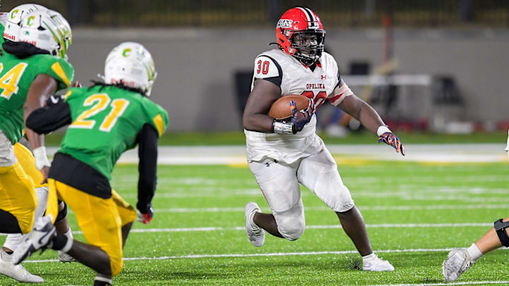 Opelika's Javari Johnson (30) carries the ball against Carver during their game at Cramton Bowl in Montgomery, Ala., on Thursday October 24, 2024.
