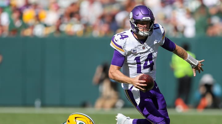 Minnesota Vikings quarterback Sam Darnold (14) escapes from Green Bay Packers defensive end Kingsley Enagbare (55) on Sunday, September 29, 2024, at Lambeau Field in Green Bay, Wis. The Vikings won the game, 31-29. Minnesota Vikings quarterback Sam Darnold (14) escapes from Green Bay Packers defensive end Kingsley Enagbare (55) on Sunday, September 29, 2024, at Lambeau Field in Green Bay, Wis. The Vikings won the game, 31-29.