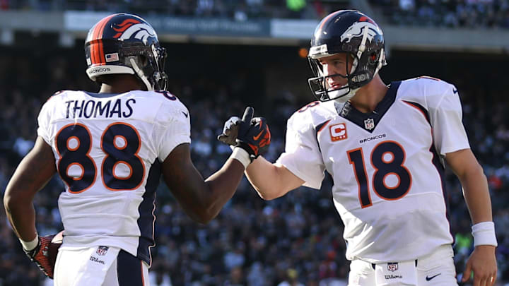 Dec 29, 2013; Oakland, CA, USA; Denver Broncos wide receiver Demaryius Thomas (88) celebrates with quarterback Peyton Manning (18) after scoring a touchdown against the Oakland Raiders during the second quarter at O.co Coliseum. 