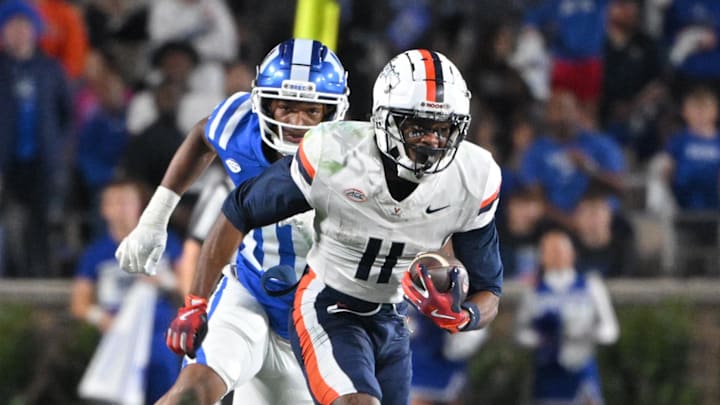 Nov 15, 2025; Durham, North Carolina, USA;  Virginia Cavaliers wide receiver Trell Harris (11) runs the ball against  Duke Blue Devils defensive end Tyshon Reed (10) during the third quarter at Wallace Wade Stadium. Mandatory Credit: Zachary Taft-Imagn Images