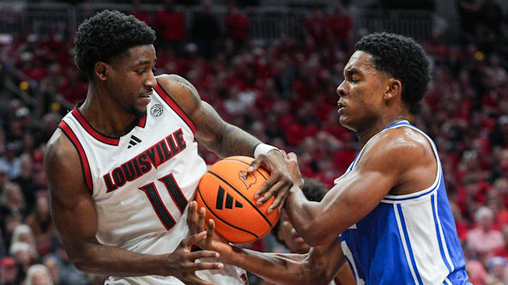 Louisville Cardinals guard Kobe Rodgers (11) and Duke Blue Devils guard Caleb Foster (1) battled for control in the second half as the Blue Devils rallied to beat the Cards 84-73 Tuesday night at KFC Yum Center January 6, 2026. Duke shot 70 percent in field goals in the second half after only 36 percent in the first.