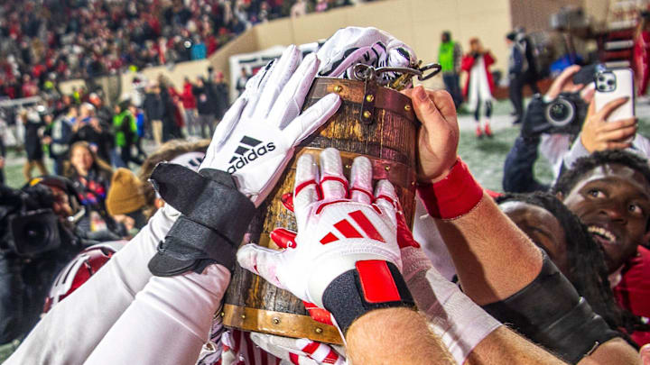 The Hoosiers touch the Old Oaken Bucket after the Indiana versus Purdue football game at Memorial Stadium on Saturday, Nov. 30, 2024.