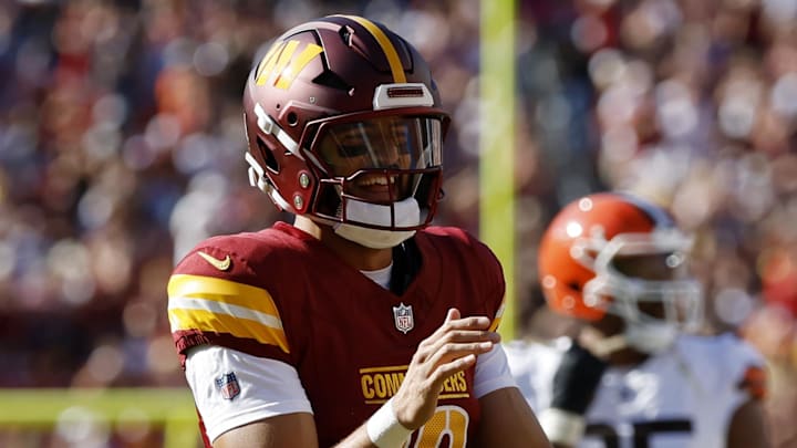 Oct 6, 2024; Landover, Maryland, USA; Washington Commanders quarterback Marcus Mariota (18) smiles while jogging onto the field against the Cleveland Browns during the fourth quarter at NorthWest Stadium. Mandatory Credit: Geoff Burke-Imagn Images Oct 6, 2024; Landover, Maryland, USA; Washington Commanders quarterback Marcus Mariota (18) smiles while jogging onto the field against the Cleveland Browns during the fourth quarter at NorthWest Stadium. Mandatory Credit: Geoff Burke-Imagn Images