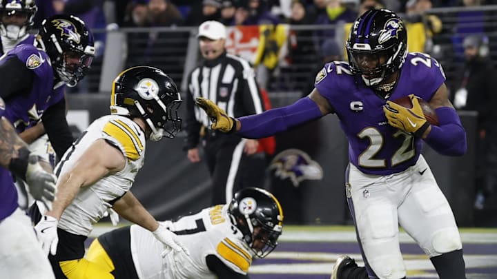Jan 11, 2025; Baltimore, Maryland, USA; Baltimore Ravens running back Derrick Henry (22) carries the ball as Pittsburgh Steelers linebacker Payton Wilson (41) chases in an AFC wild card game at M&T Bank Stadium. Mandatory Credit: Geoff Burke-Imagn Images
