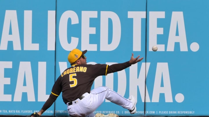 Feb 23, 2026; Peoria, Arizona, USA;  San Diego Padres right fielder Ramon Laureano (5) chases down a two run triple by Milwaukee Brewers shortstop Jett Williams (76) in the first inning at Peoria Sports Complex. Mandatory Credit: Jayne Kamin-Oncea-Imagn Images