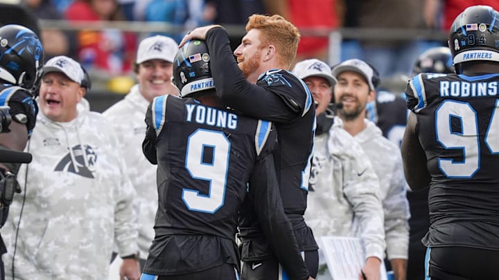 Nov 24, 2024; Charlotte, North Carolina, USA; Carolina Panthers quarterback Bryce Young (9) is congratulated by quarterback Andy Dalton (14) after his touchdown drive against the Kansas City Chiefs during the second half at Bank of America Stadium. 