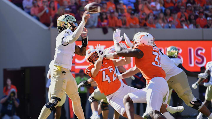 Oct 4, 2025; Blacksburg, Va.; Wake Forest quarterback Robby Ashford (2) throws a pass against Virginia Tech defensive linemen Aycen Stevens (42) and Ben Bell (33).