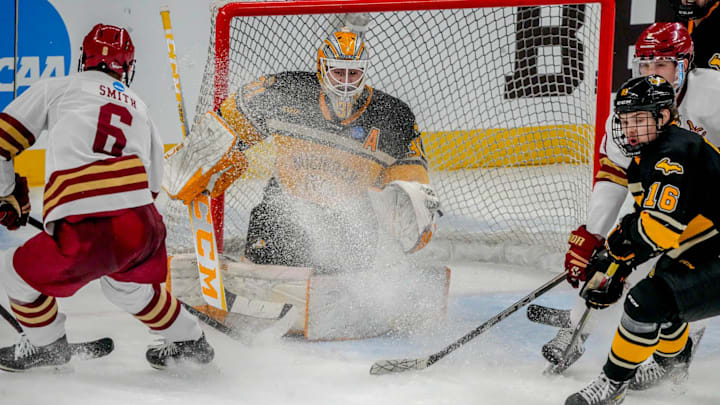 Will Smith 6 in front of the net, Isaac Gordon, 16, defends for Michigan Tech. Blake Pietila in net.
