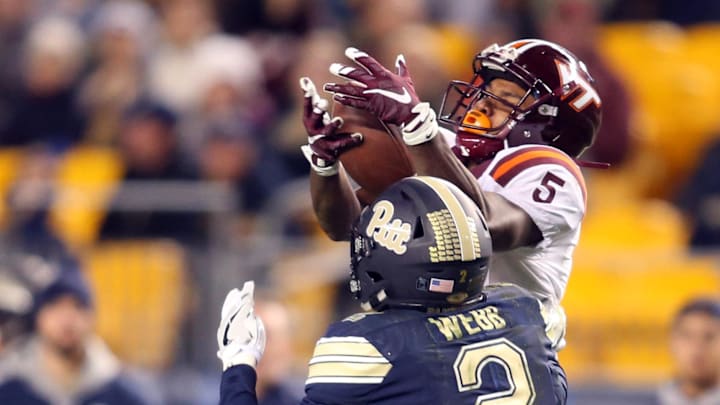 Oct 27, 2016; Pittsburgh, PA, USA;  Virginia Tech Hokies wide receiver Cam Phillips (5) catches a pass against Pittsburgh Panthers defensive back Terrish Webb (2) during the second half at Heinz Field. Virginia Tech won 39-36. Mandatory Credit: Charles LeClaire-Imagn Images