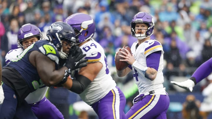 Dec 22, 2024; Seattle, Washington, USA; Minnesota Vikings quarterback Sam Darnold (14) looks to pass against the Seattle Seahawks during the first quarter at Lumen Field.