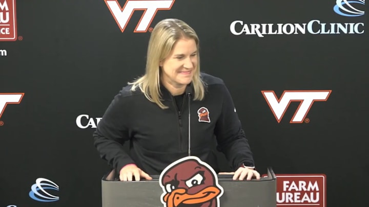 Virginia Tech Women's Basketball head coach Megan Duffy behind the microphone at her press conference.