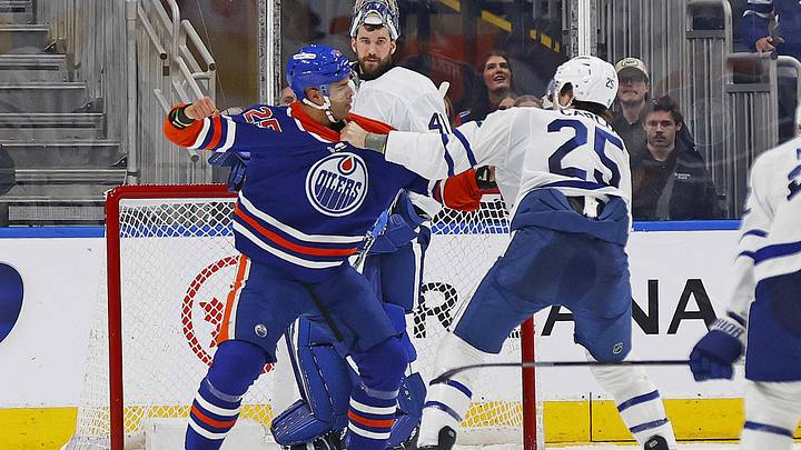 Feb 3, 2026; Edmonton, Alberta, CAN; Edmonton Oilers defensemen Darnell Nurse (25) and Toronto Maple Leafs defensemen Brandon Carlo (25) fight during the second period at Rogers Place. Mandatory Credit: Perry Nelson-Imagn Images
